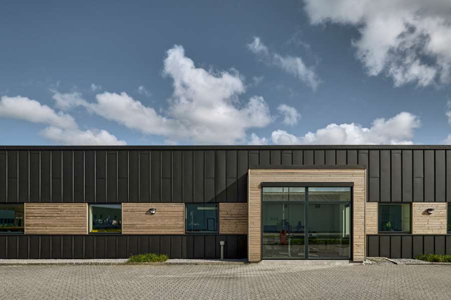 Black steel profiles and warm wood create striking contrasts on headquarters facade, Jernvej 19, 6900 Skjern, Denmark